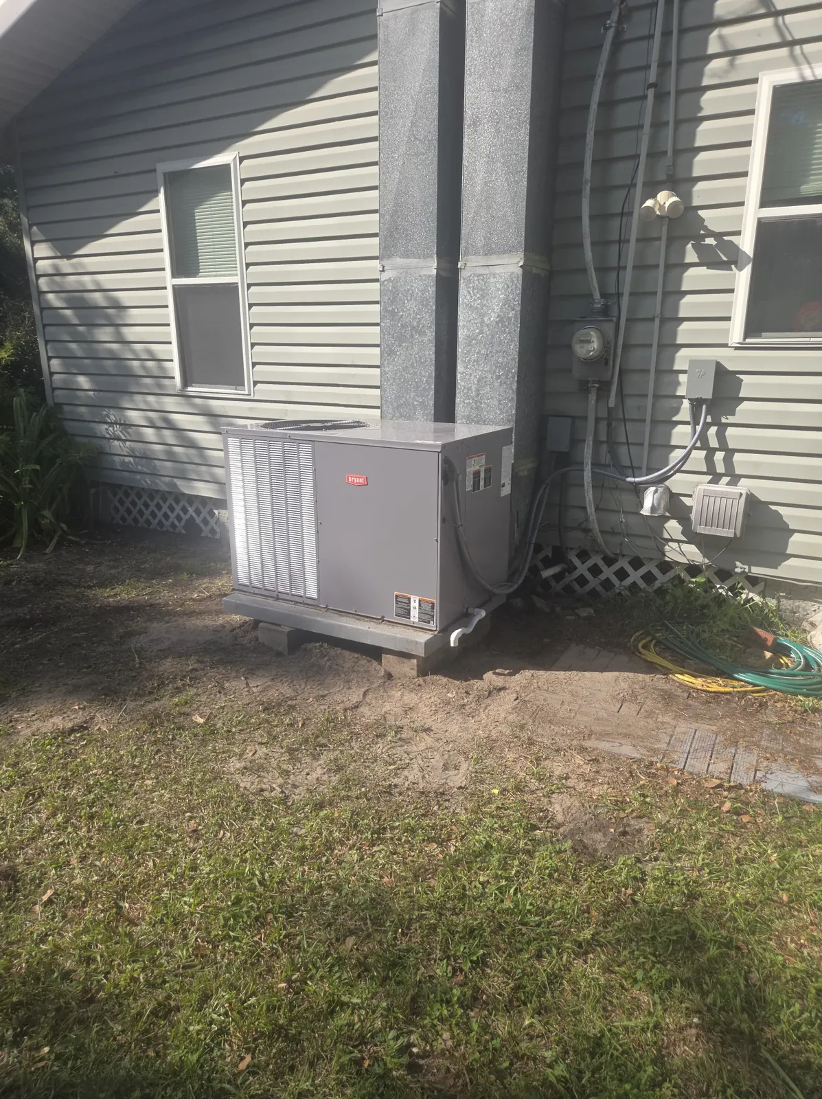 Newly installed Bryant package air conditioning unit outside a Perry, Florida rental house