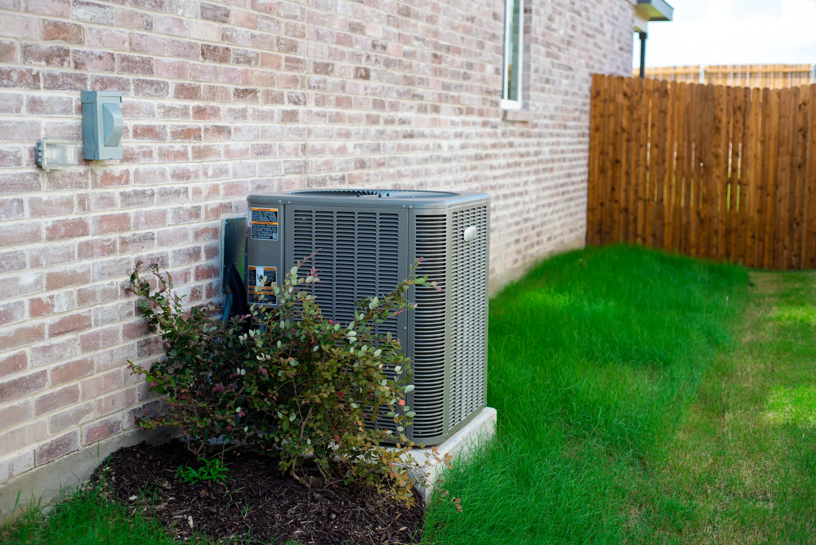 Outdoor central air conditioning condenser unit at a Florida home